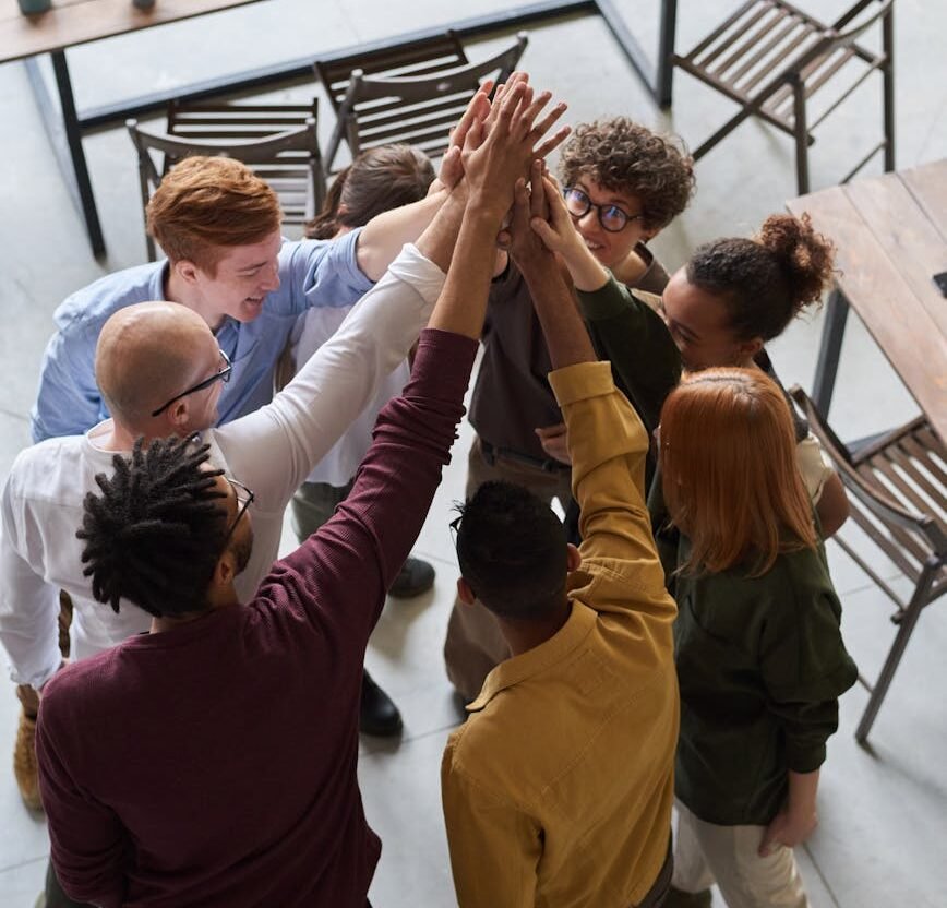 photo of people holding each other s hands
