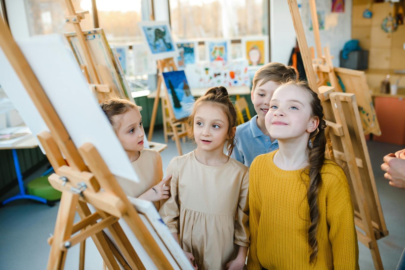 children standing near an easel
