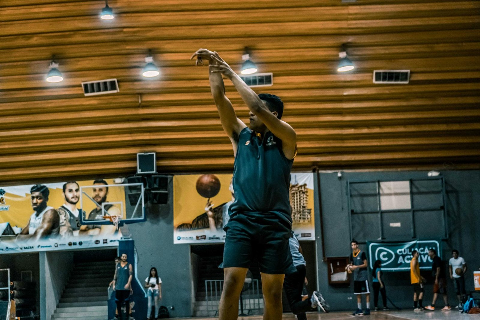 black haired man wearing black sleeveless shirt and black shorts