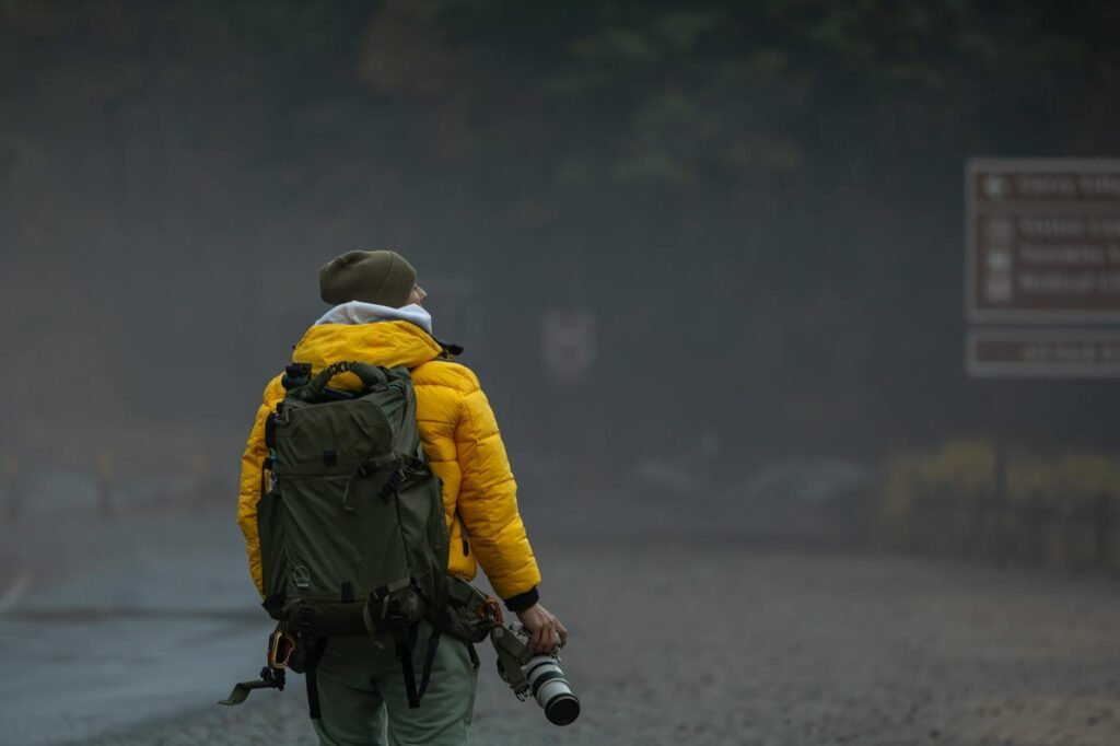 adventurous photographer in misty landscape