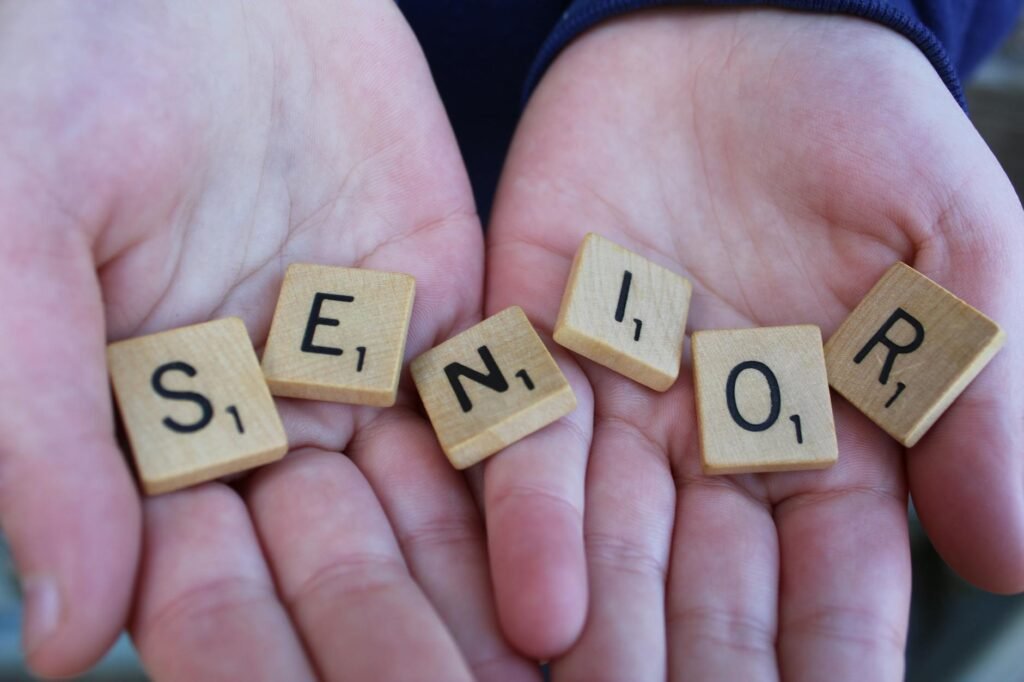 senior scrabble tiles held in hands