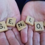 senior scrabble tiles held in hands