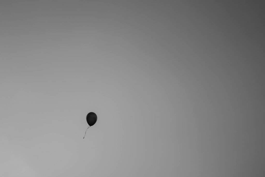 black balloon against a gray sky