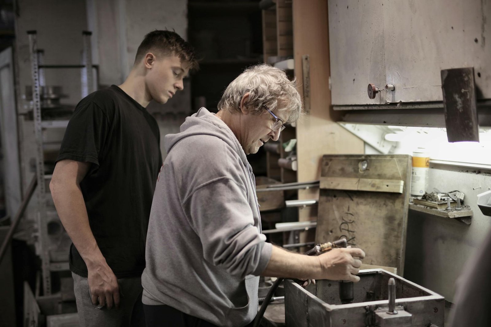 master showing apprentice how handling detail