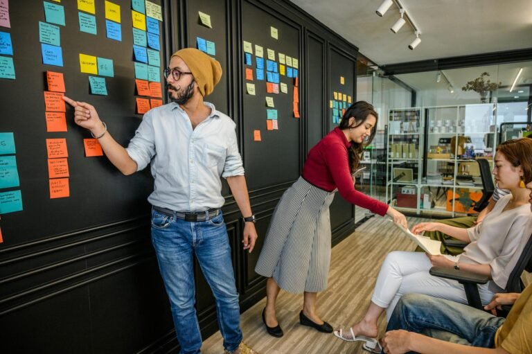 man in blue dress shirt pointing at blue note