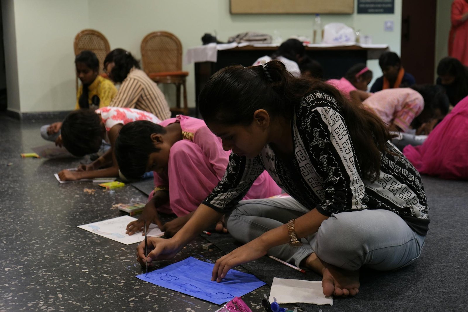 woman in black and white long sleeve shirt sitting on chair