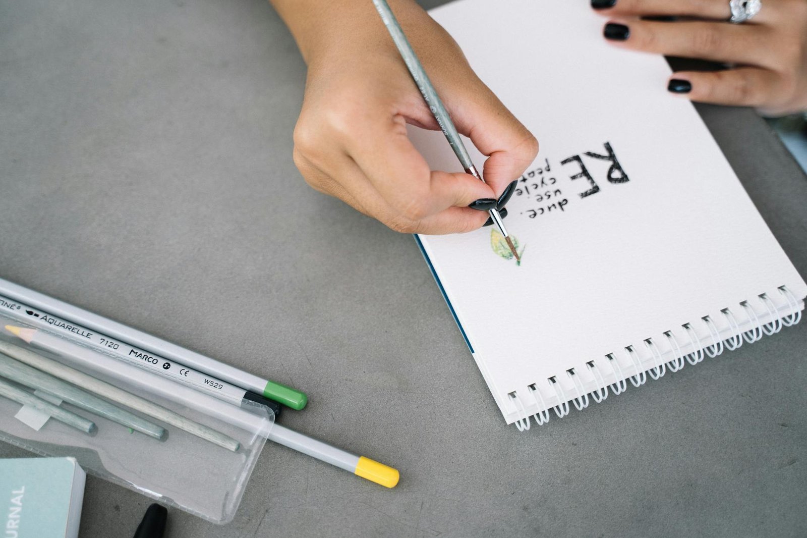 person writing on white paper
