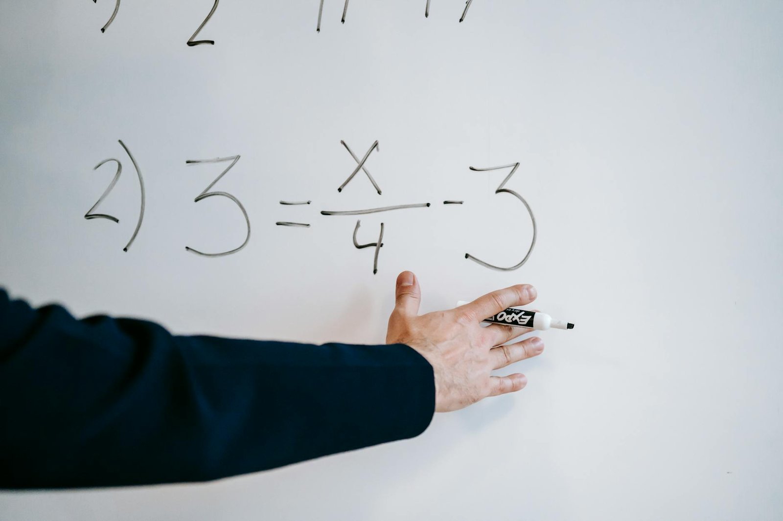 photo of person teaching on white board