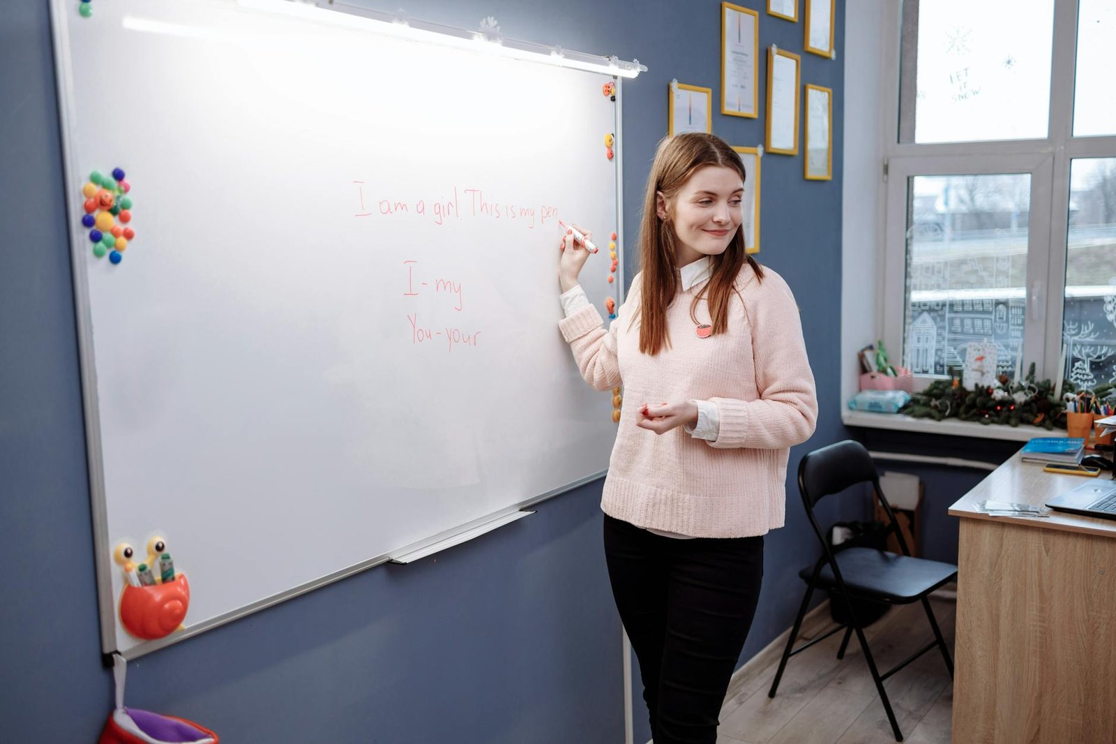 woman standing in front of a room writing on whiteboard