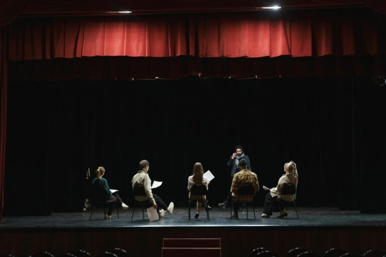 group of people sitting on chair on stage