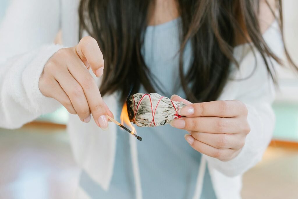 woman in white shirt holding orange and white lollipop
