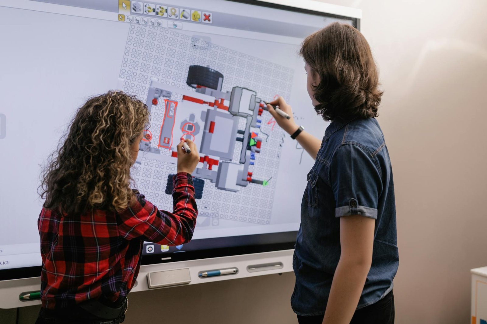 two students using an interactive board