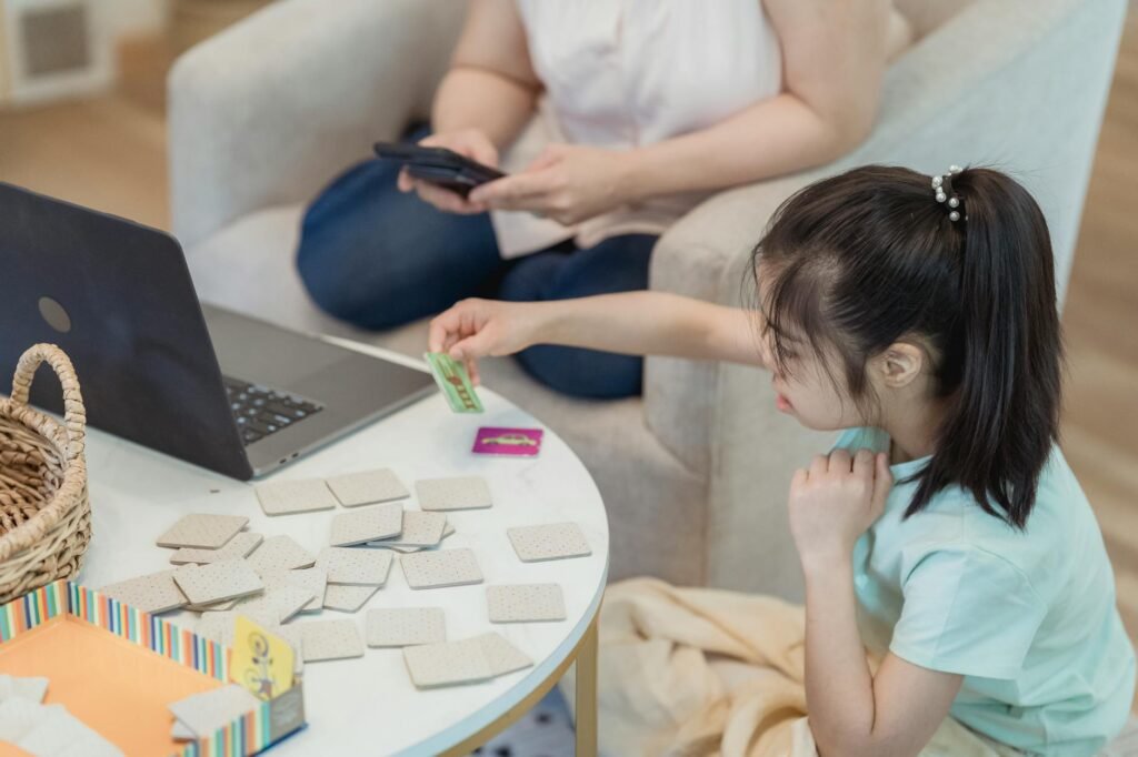 girl in a green shirt playing with cards