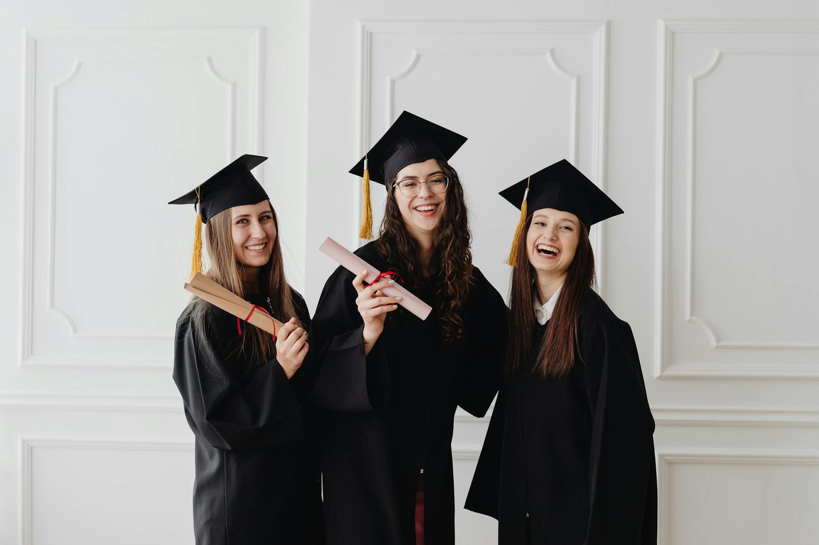 happy women in academic dress