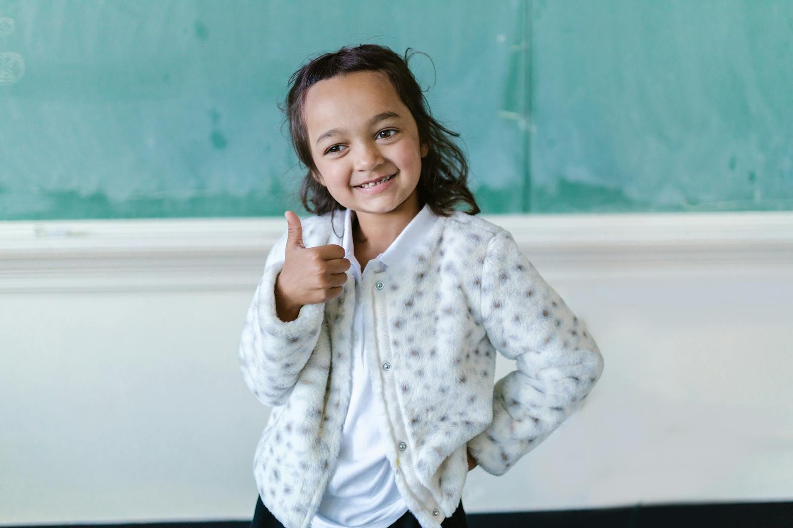 a girl doing a thumbs up