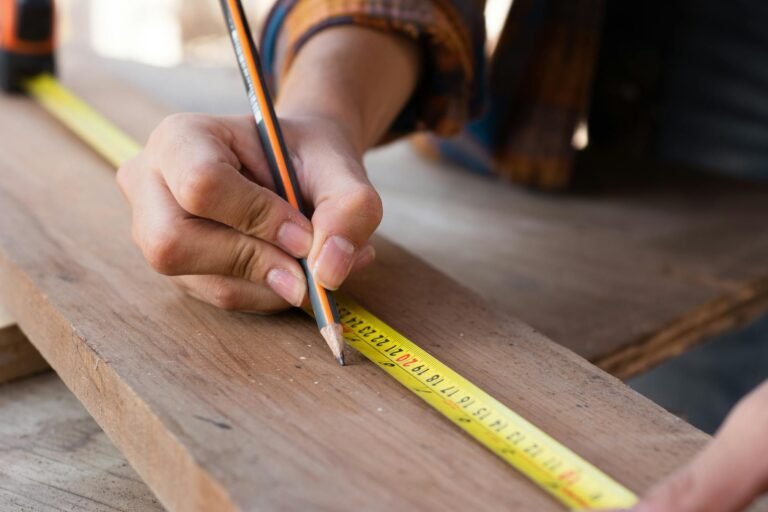 woman measuring with yellow pencil on board