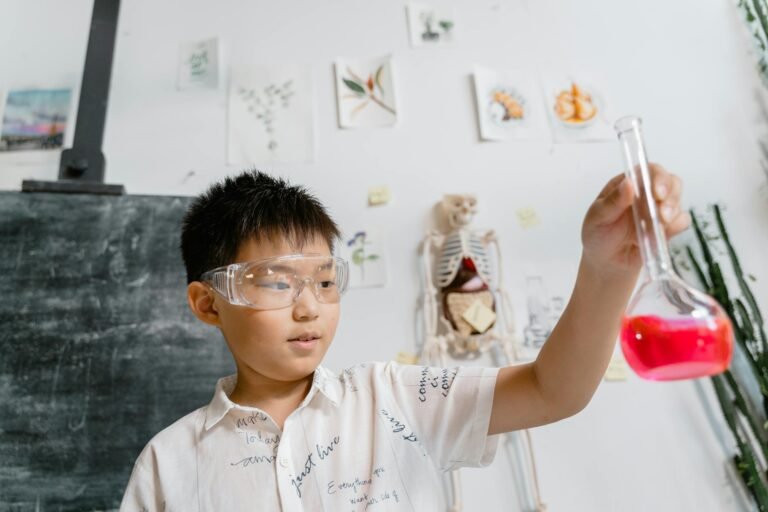 a boy holding a beaker