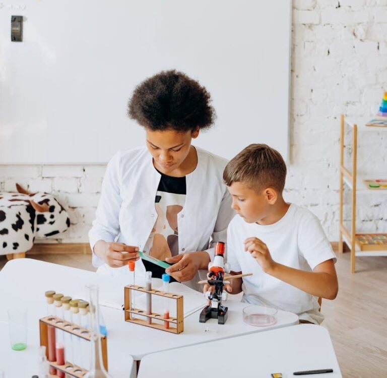 teacher and little boy experimenting with a chemistry kit