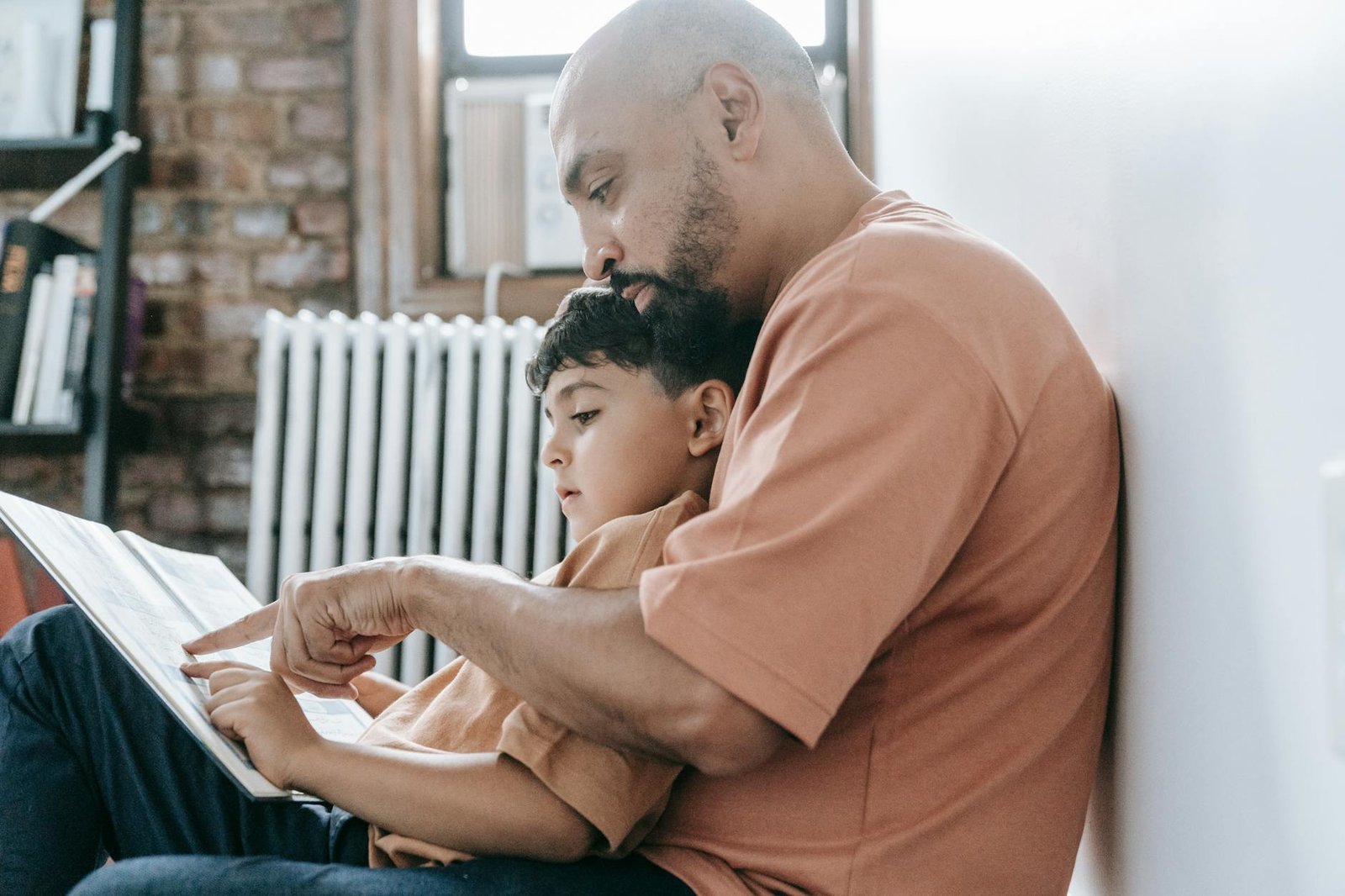 man and his son sitting on the floor