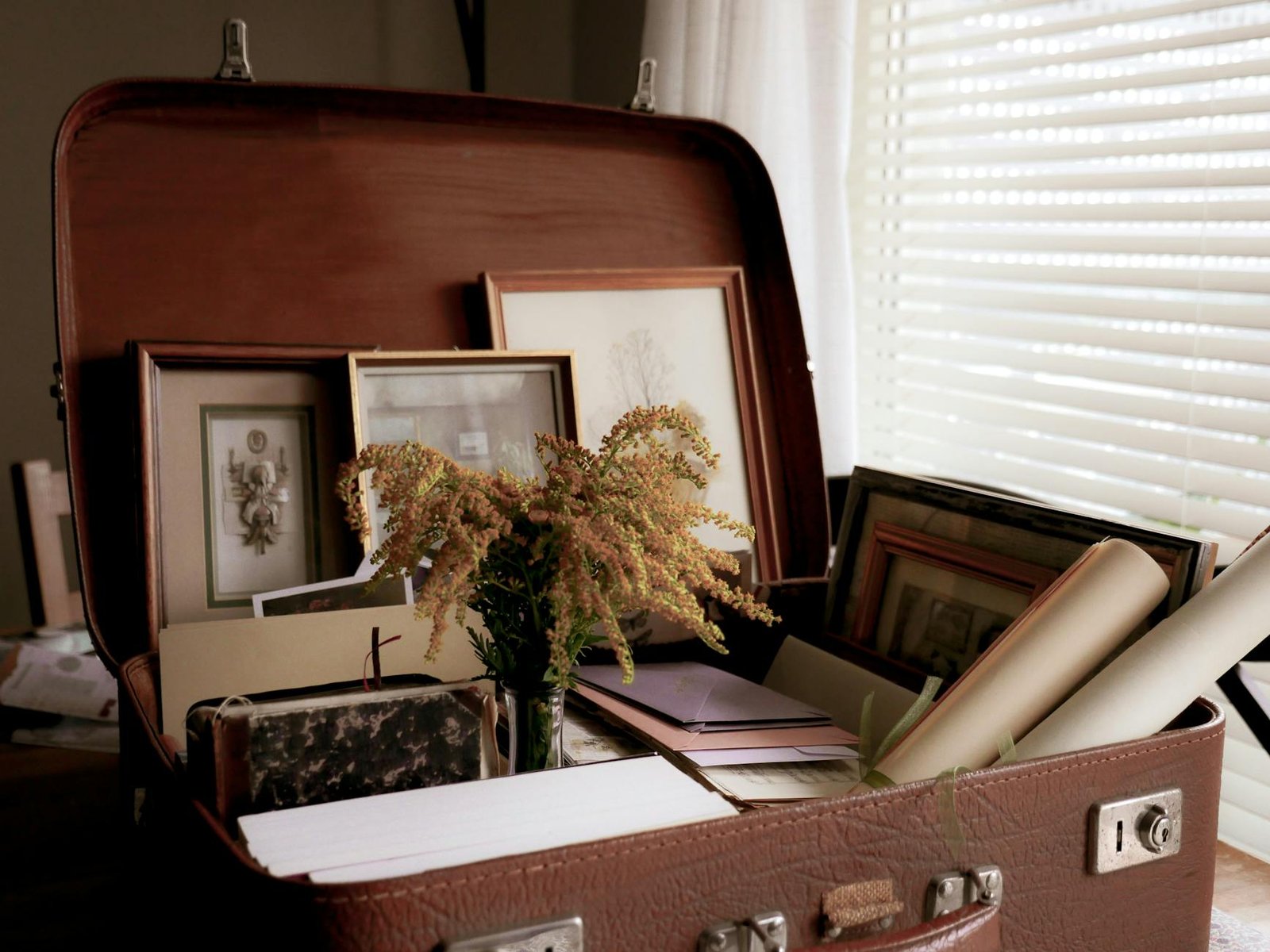 vintage suitcase with photo frames and papers