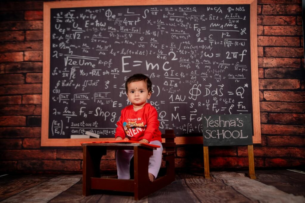 adorable baby in classroom with chalkboard