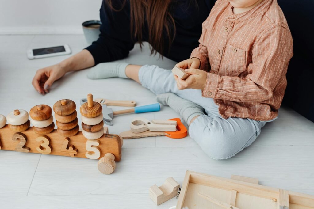 woman and child playing with wooden toys